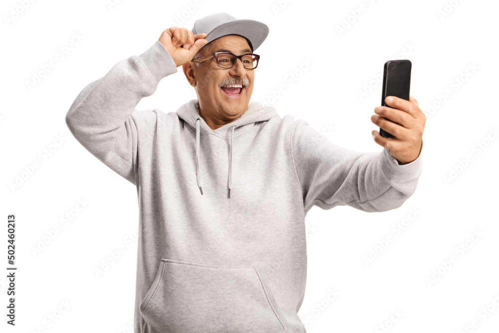 Smiling cool mature man taking a selfie with a smartphone Smiling cool mature man taking a selfie with a smartphone