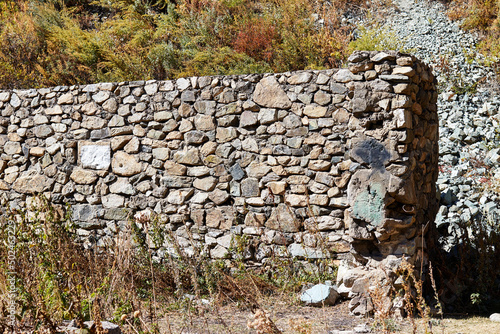 wall of a ruined house made of stones photo