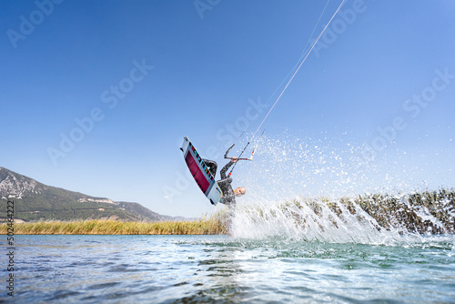 Water sports athlete having kitesurfing session, Akyaka, Turkey photo