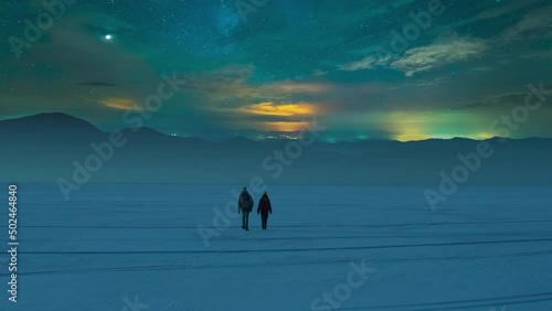 The two travelers walking through the night snow field