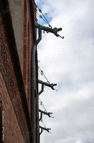 Gargoyles at Saint John the Baptist Basilica, church built in XIV century in Orneta, Warmia, Poland. photo