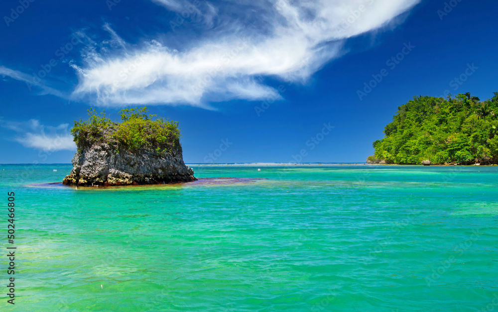 Beautiful caribbean landscape with secluded turquoise reef lagoon, rock, clear blue sky - Port Antonio, San San beach, Jamaica