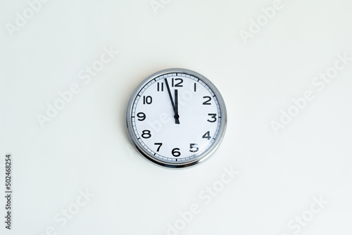 Clock at 12 o'clock on white background