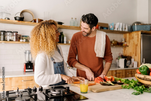Couple preparing food in kitchen.