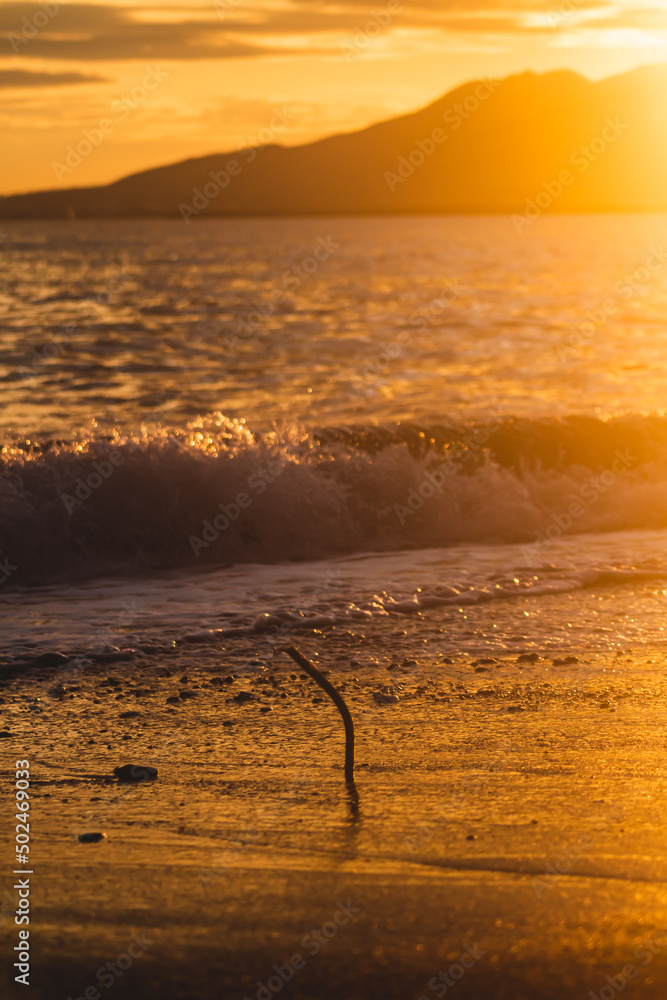 Fototapeta premium Metal piece on the beach in Malaga, Spain, at the sunset.