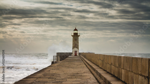 Lighthouse in Porto, Portugal, on a stormy day and big waves.
