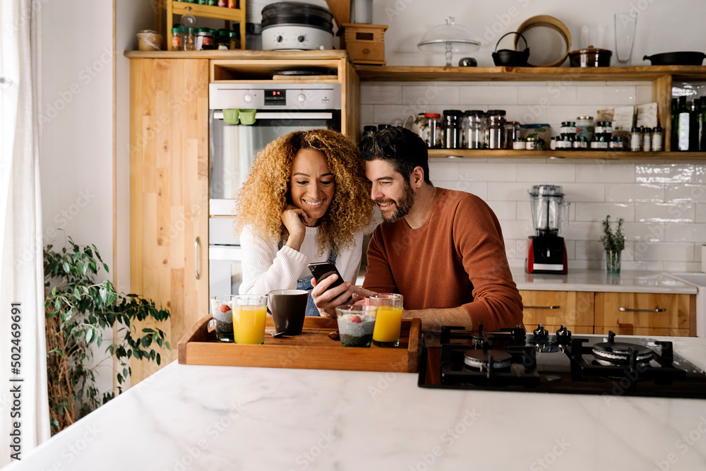 Couple having breakfast in kitchen. Couple having breakfast in kitchen.