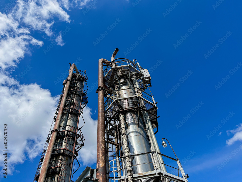 The main distillation column of oil and petroleum products in close-up with copyspace