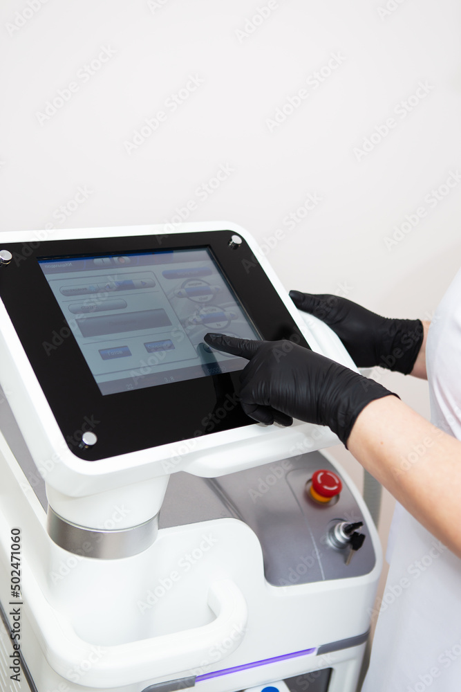 Fototapeta premium Professional laser hair removal machine, screen for setting up the hair removal process. Professional cosmetology, body epilation. Body care concept.