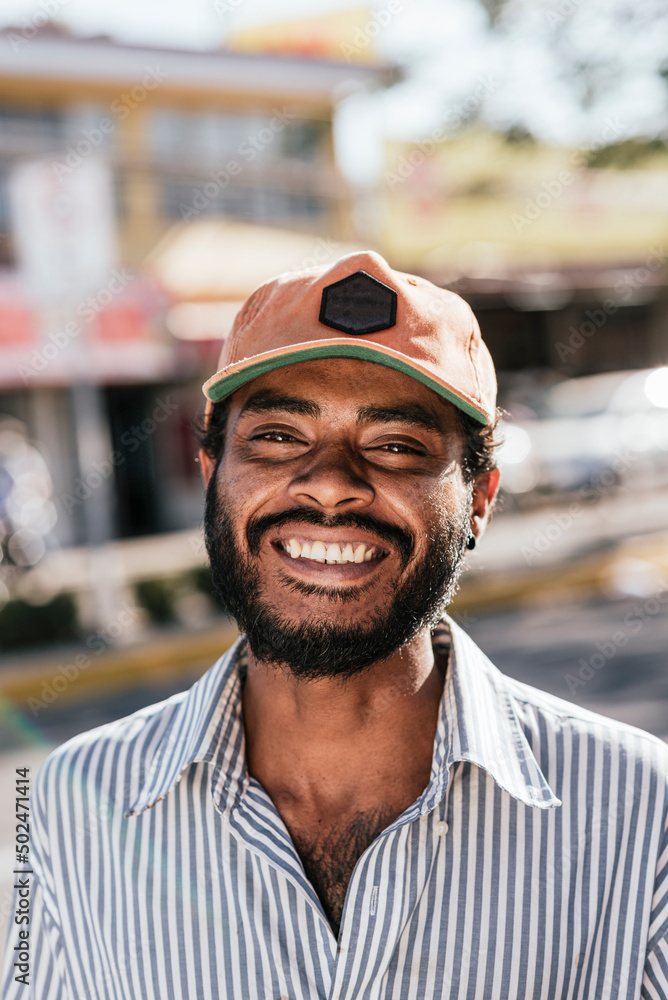 Man in street condition with cap and beard very smiling looking at the camera. Man in street condition with cap and beard very smiling looking at the camera.