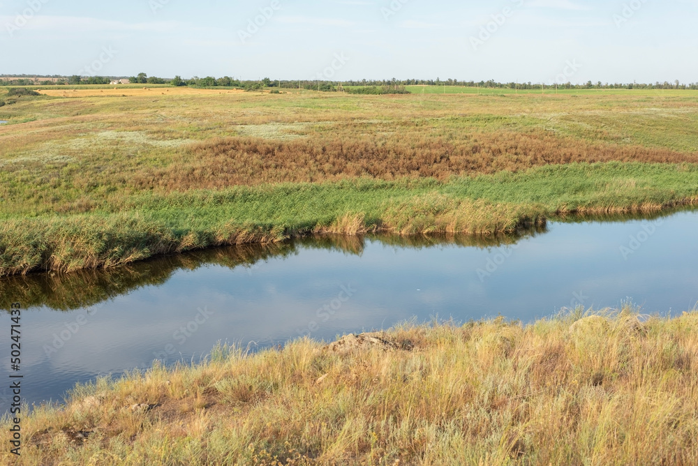 rural landscape of a field with a river on the background of a cloudy sky august ukraine rural landscape of a field with a river on the background of a cloudy sky august ukraine