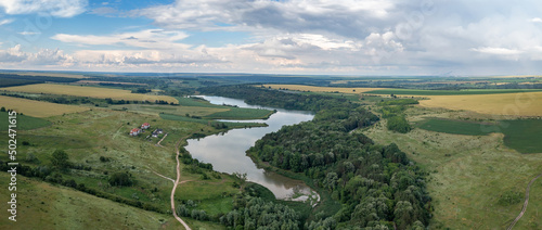 Panoramic aerial view from the drone of beautiful countryside with lake like a snake