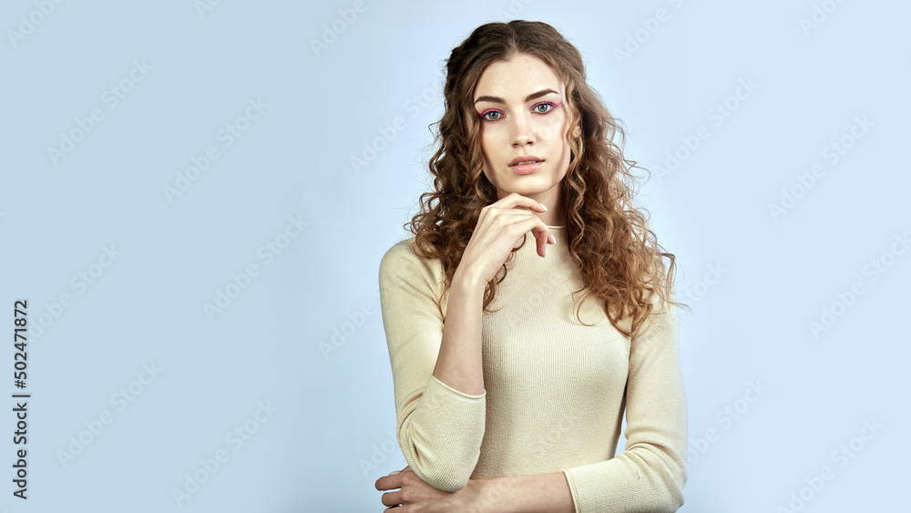 curly-haired model poses looking at the camera curly-haired model poses looking at the camera