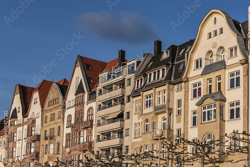 Beautiful traditional medieval buildings along the picturesque river Rhine promenade at sunset. DUSSELDORF, GERMANY. © dbrnjhrj