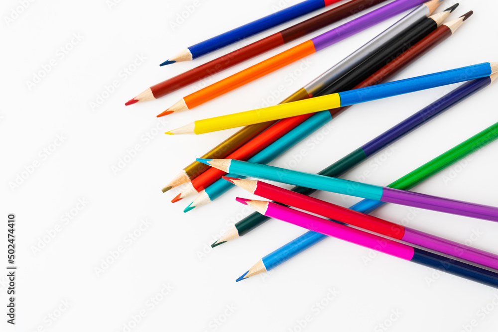 Close-up macro photography of scattered colored pencils for drawing. Place for an inscription. Close-up macro photography of scattered colored pencils for drawing. Place for an inscription.