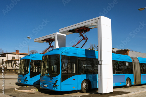 Electric buses are in the parking lot on a charge. Eco-friendly urban public transport