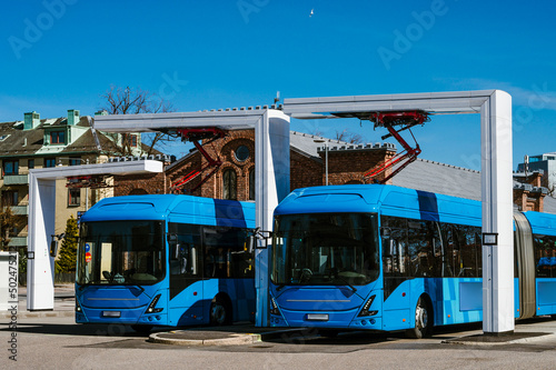 Electric buses are in the parking lot on a charge. Eco-friendly urban public transport