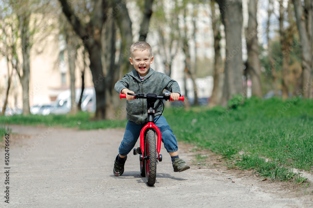 boy riding a bike on the street. Learning to ride a bike concept