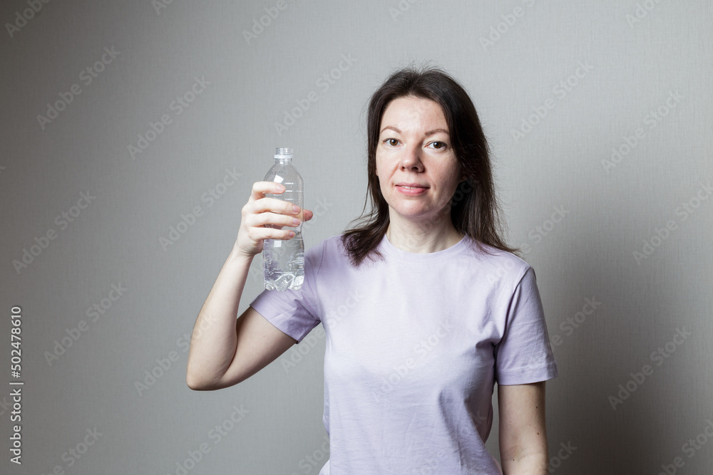 woman holding a bottle of water. woman holding a bottle of water.