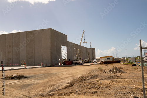 Construction site for a warehouse being built using tilt-up prefabricated concrete panels on concrete foundations.