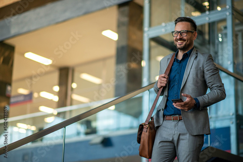 Business man using phone and walking. Stock photo photo