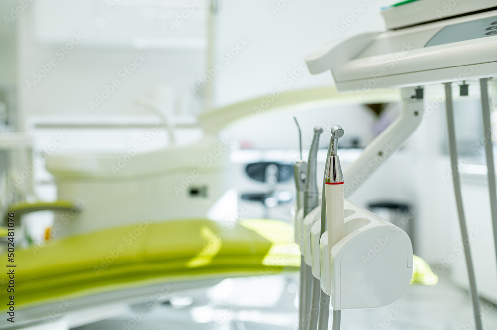 Detail of a dental tools attached to a dental chair in a dental clinic Detail of a dental tools attached to a dental chair in a dental clinic