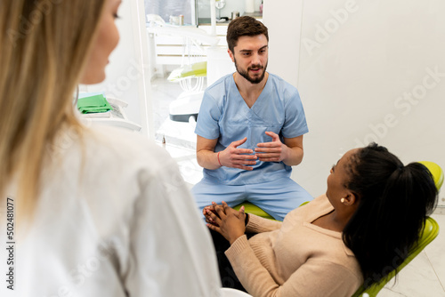 Dentist and patient talking about treatments in a consultation