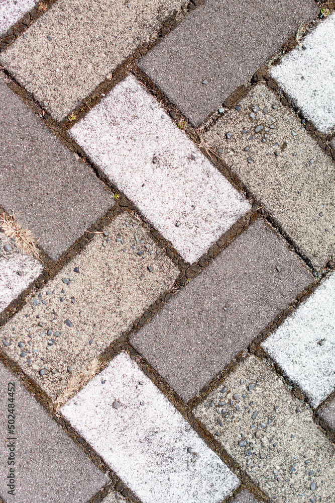 Closeup of sidewalk paved with rectangular white and gray tiles in top view Closeup of sidewalk paved with rectangular white and gray tiles in top view