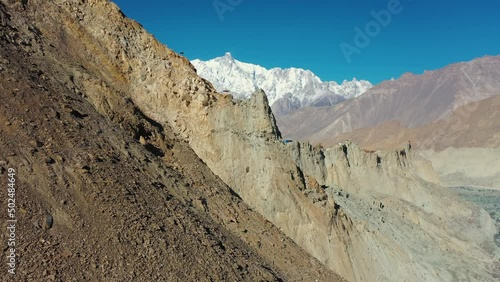 Aerial Panning A Steep Mountainside And Rugged Glacier Valley - Hunza Valley, Pakistan photo