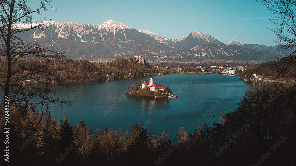 Assumption of Maria Church on island within Bled lake surrounded by Alps mountaines, Slovenia.