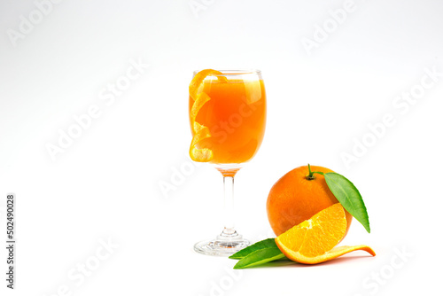 Isolated drink. Glass of orange juice and slices of orange fruit isolated on white background.