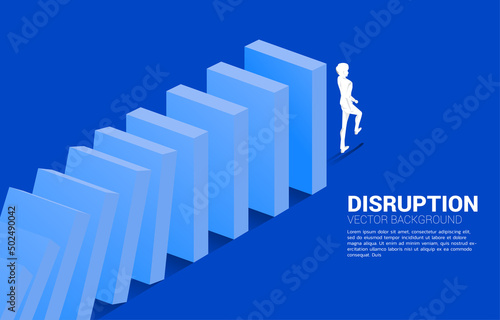 Silhouette of businessman walking from the end of domino collapse. Concept of business industry disrupt