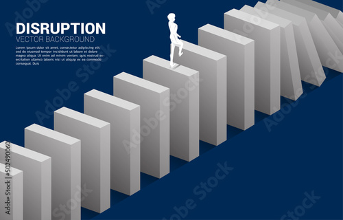 Silhouette of businessman walking on domino collapse. Concept of business industry disrupt