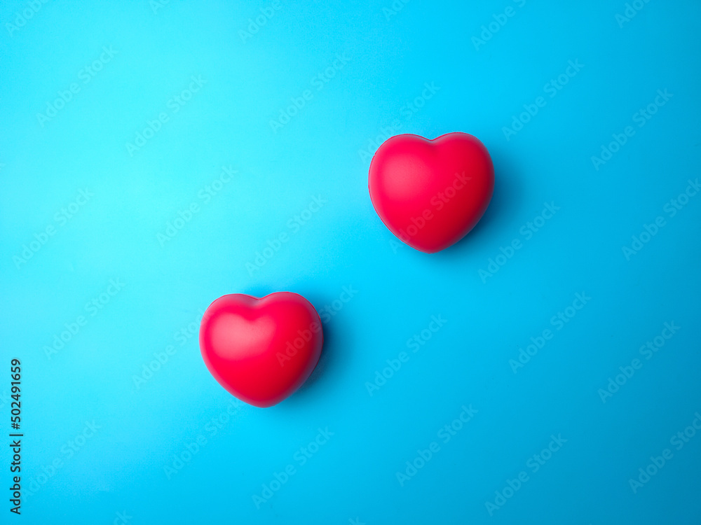 Top view two red heart shape on blue background. Can use for heart check up or love concept