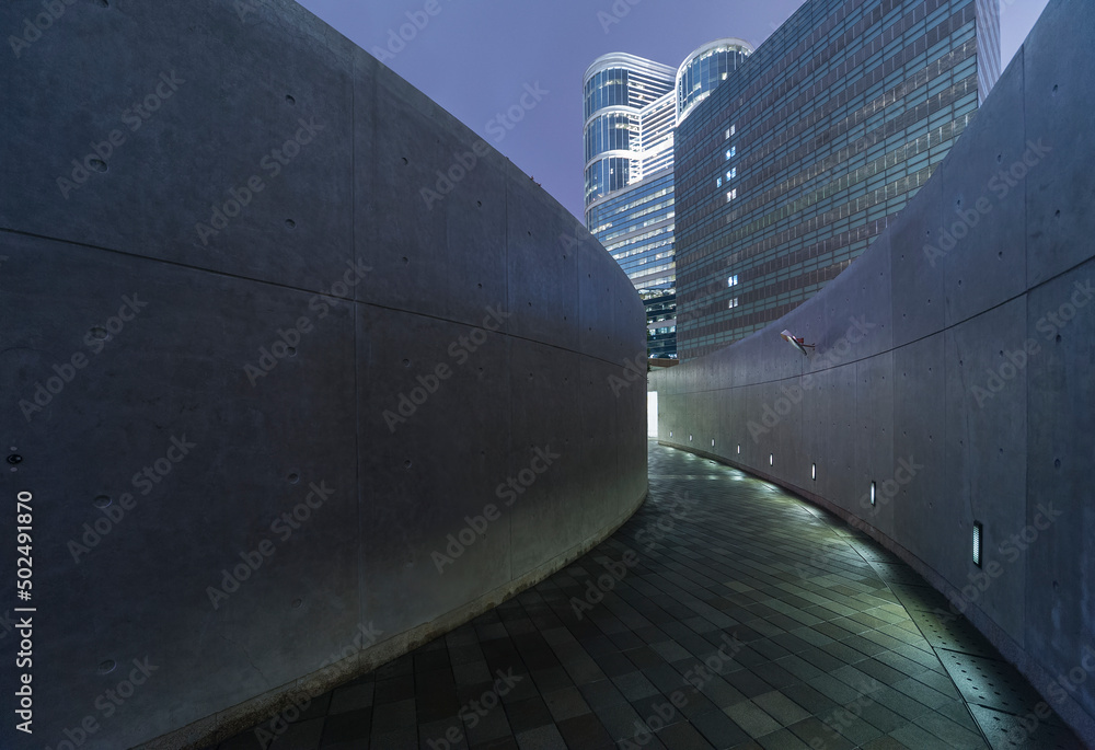 Empty modern pedestrian walkway in downtown at night