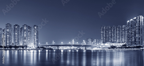 Panorama of harbor and skyline of Hong Kong city at night © leeyiutung