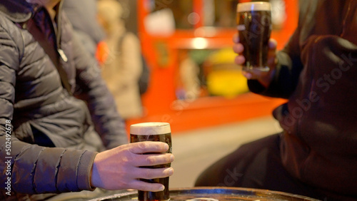 Photography Guys drinking a beer in the Temple Bar district of Dublin by night - Ireland tra