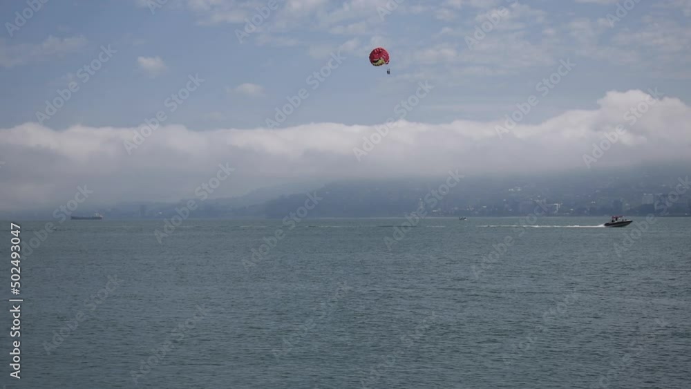 parachutist in the sky over the sea. High quality FullHD footage parachutist in the sky over the sea. High quality FullHD footage