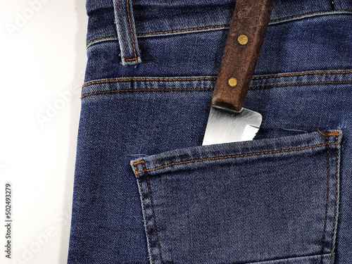 Knife in your pants pocket. Killer concept. Crime by white weapon.