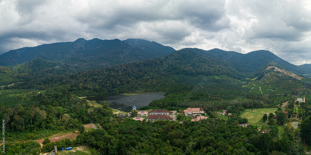 Aerial drone view of rural scenery with tropical trees in Mount Ledang National Park, Johor, Malaysia.