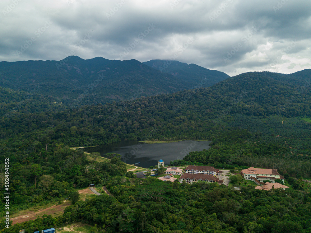 Aerial drone view of rural scenery with tropical trees in Mount Ledang National Park, Johor, Malaysia.