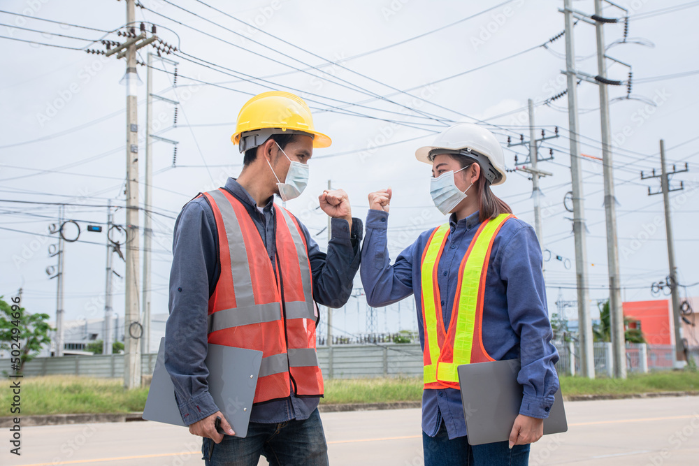 Two Asian Electrician on site service inspection power system station Two Asian Electrician on site service inspection power system station