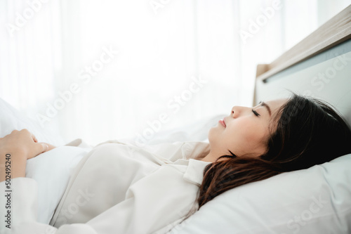 Young asian beautiful woman happy sleep on bed in morning time
