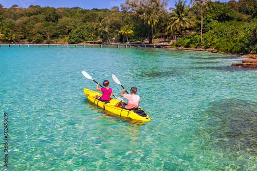 Asian senior couple on kayak in adventure travel in south east asia.