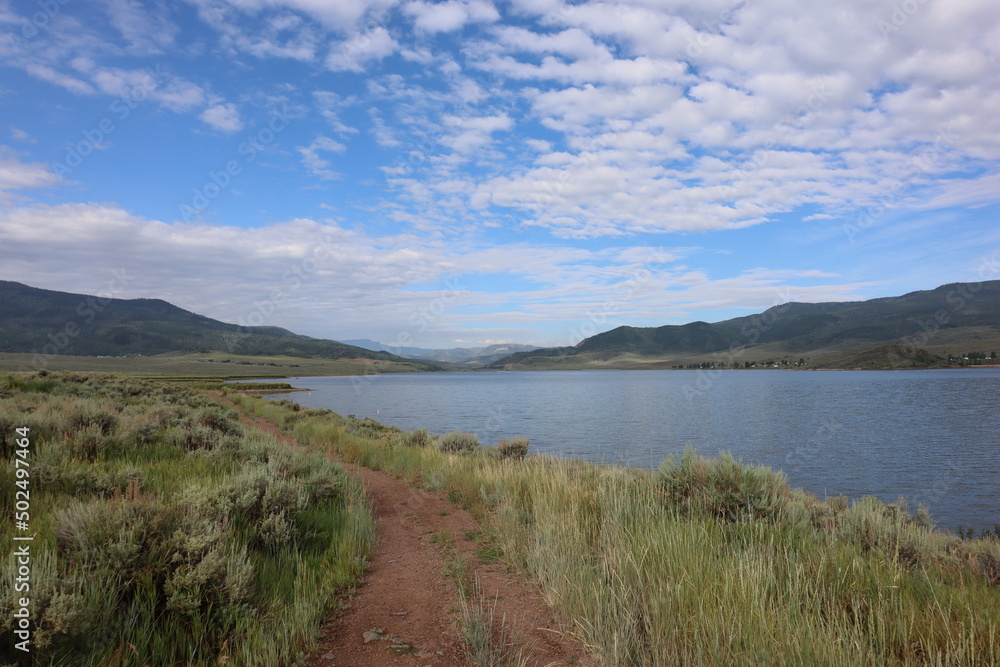 The sun shines over a lake at Stagecoach State Park in the Rocky Mountains of Colorado