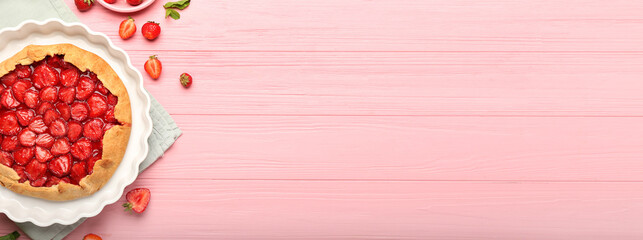 Baking dish with tasty strawberry pie on pink wooden background with space for text