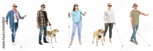 Different blind people with guide dogs and walking canes on white background photo