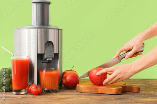Woman making fresh juice at...