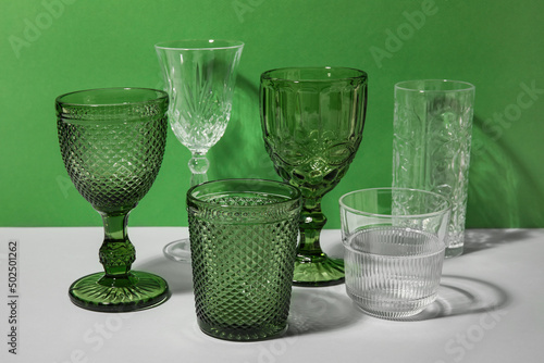 Stylish empty glasses on gr...