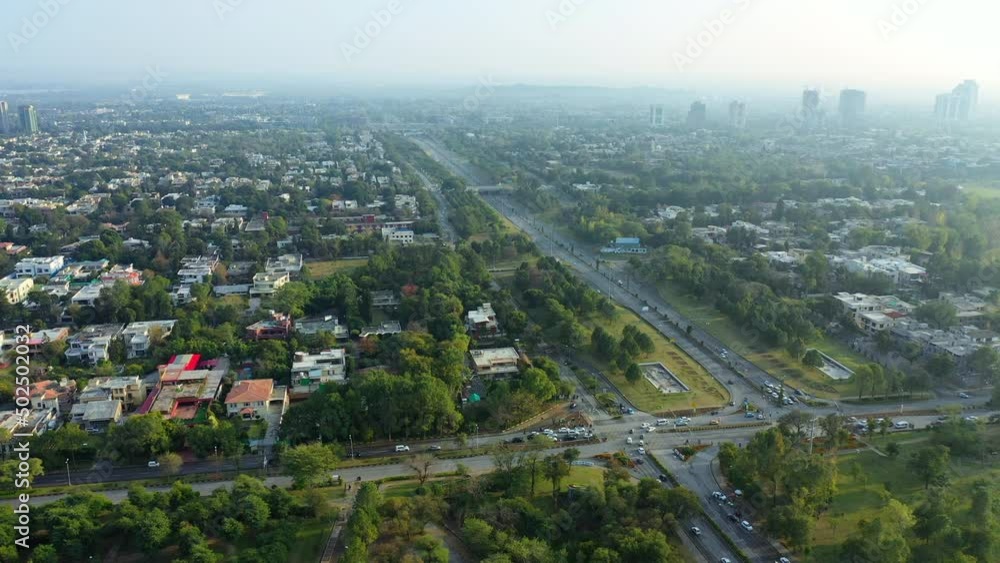 Aerial Panning Over A Highway And Sprawling City On A Hazy Morning With Highrise Towers In The Distance - Islamabad, Pakistan Aerial Panning Over A Highway And Sprawling City On A Hazy Morning With Highrise Towers In The Distance - Islamabad, Pakistan